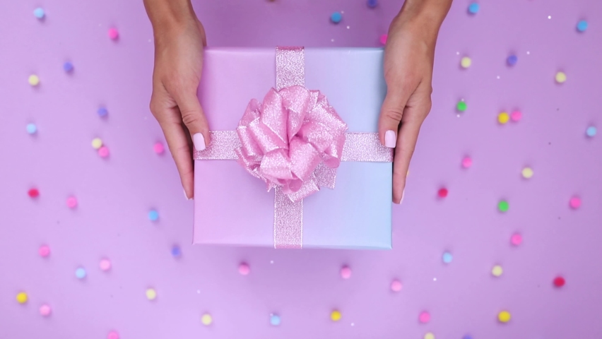 hands put a gift box on the table are presented with a gift Royalty-Free Stock Footage #1078314116