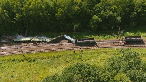 Arial view. Train accident. Rescue and relief works in progress locomotive derailed, damage of compartment after train derailed, strategy obstruction challenges train track that is broken road block