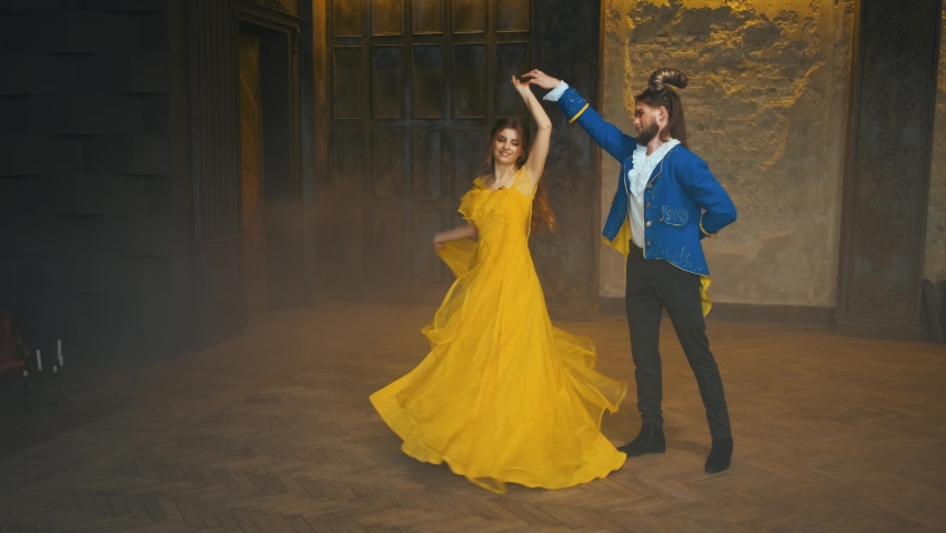 Happy married couple dancing at carnival ball. Fantasy beauty woman smiling spinning yellow vintage dress fluttering. Man fairytale beast monster, blue retro jacket. Prince and princess joyful dancers | Shutterstock HD Video #1078317191