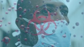 Animation of warning text and virus cells over man wearing face mask. global covid 19 pandemic concept digitally generated video.