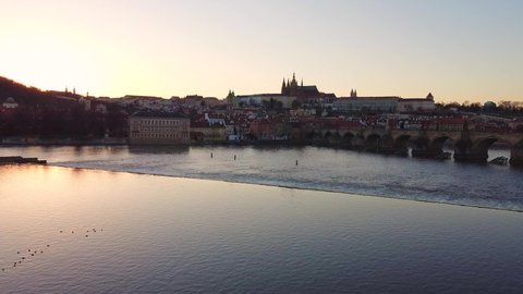 Aerial view of Prague Old Town architecture and Charles Bridge over Vltava river at sunset. Old Town of Prague, Czech Republic.