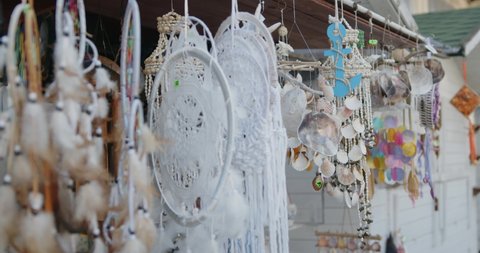 White dreamcatchers in a local market on a streets, lots of colorful decorations to hang 