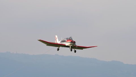 Thiene, Italy JULY, 8, 2021 Private propeller general aviation airplane landing in a grass airfield. Robin DR400 OE-DFS