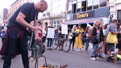 LONDON, UK – August 28, 2021: Siren outside steakhouse at Extinction Rebellion Animal Rights Protest, London, England, UK