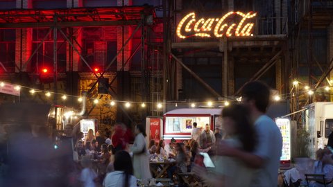 Belarus, Minsk - 14 August, 2021: Timelapse Coca Cola art space festival, couple in love in the midst of everyone, hipster place, art space in an old factory, food truck fair and crowded place