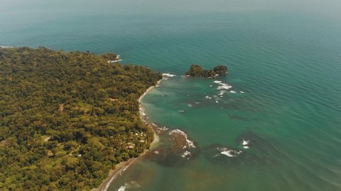 Cinematic flight over coastline of Punta Mona with tropical forest and beach in Costa Rica - Beautiful wide view of Caribbean Sea