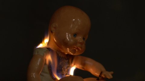 SYDNEY, NSW, AUSTRALIA. FEBRUARY 21 2020. Sinister burning doll falls over.