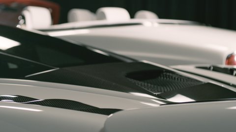 White McLaren luxury sportscar with wing, back end, close up, studio light