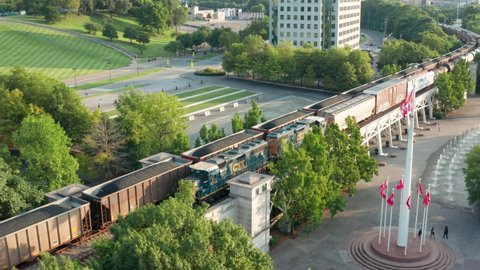 Nashville , Tn , United States - 08 09 2021: Bicentennial Mall at Tennessee state capitol. Flags wave in breeze. CSX train locomotive.