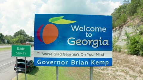 Dade County , GA , United States - 08 11 2021: Welcome to Georgia sign by interstate highway in Dade County. Aerial on summer day.