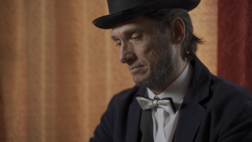 The man in the suit of President Abraham Lincoln portrait