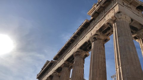 Right to left sliding shot of the Columns of Parthenon. Ruins of antique temple in Athenian Acropolis in Greece, Europe. Dedicated to the goddess Athena. Detail view on a sunny day in 4k resolution