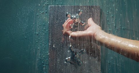 Cinematic close up of female hand opening tap before to take hot relaxing shower in a luxury wellness center. Concept of purity, freshness, personal hygiene, spa resort, freedom, skincare, healthcare.