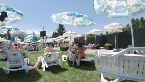 Bansko, Bulgaria - 20 Aug, 2021: Tourists enjoy thermal spa pool resort during summer vacation in Bansko, Bulgaria