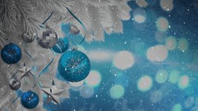 Animation of snow falling over silver and blue christmas baubles decoration. christmas, tradition and celebration concept digitally generated video.