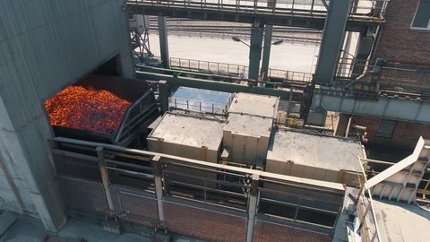 The process of making coke oven coal. A car with hot burning coke coal drives in for cooling. Processes at a metallurgical plant