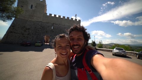 happy tourists couple taking selfie photo with panorama of Campobasso in Molise region, Italy