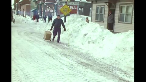 CIRCA 1977 - Footage shot from a snow plow as it clears a road and backs up in Buffalo, New York.