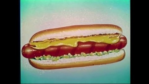 CIRCA 1960s - Large hot dogs are advertised at a drive-in theater's concession stand.