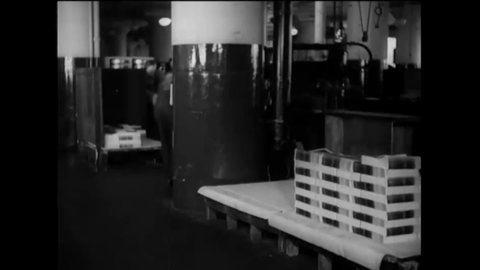CIRCA 1937 - Stacks of Life magazine are transported through a factory on large carts, and prepared for distribution.