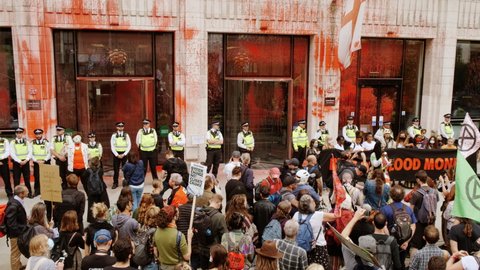 LONDON, circa 2021 - Extinction Rebellion supporters deface the exterior of The Guildhall in the City of London with fake blood during a demonstration, under the name "The Impossible Rebellion"