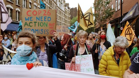 LONDON, circa 2021 - Extinction Rebellion supporters march through London's Soho District, during a 2-week demonstration against Climate Change, under the name "The Impossible Rebellion"