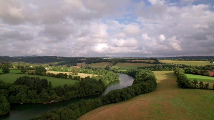 4K Drone Footage with Landscape Horizon View and Farmland Overlooking a River in France with Clouds