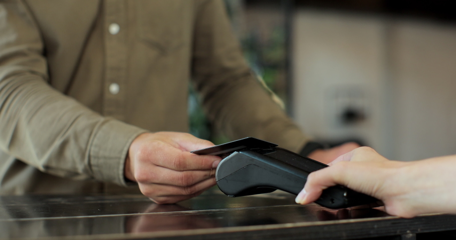 Close-up of unrecognizable caucasian man using credit card contactless payment for coffee wireless. Modern technologies and restaurant business concept. | Shutterstock HD Video #1078420442