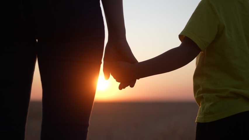 happy family mom and daughter hold hands a close-up teamwork. mother and girl kid together hands at sunset. parent girl and child happy childhood. fun daughter happy family mother day concept Royalty-Free Stock Footage #1078423238