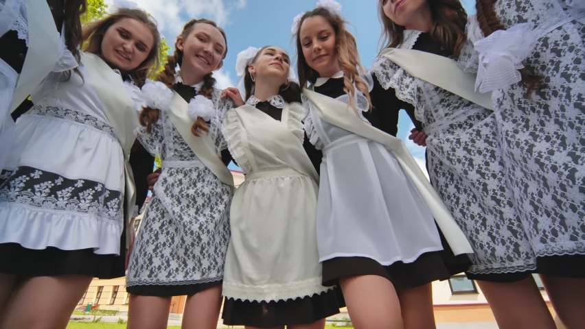Happy Russian female graduates pose on their graduation day.