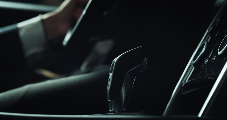 Close Up on the Hands of a Man Adjusting his Gear While Driving in a Fancy Luxurious Car. A Businessman in Trying Out a Car Before Buying it in a Dealership. Concept of Car Advertisement Royalty-Free Stock Footage #1078428452
