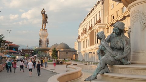 Skopje, Northern Macedonia - July 19, 2021: Warrior monument and other sculptures in Skopje city center in summer. Steadicam shot. Street scene from Skopje, capital of Northern Macedonia