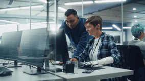 Teamwork In Diverse Office: Smiling Project Manager Talks with Woman with Disability Using Prosthetic Arm to Working on Desktop Computer. Professionals Create e-Commerce Software App Solution - Powered by Shutterstock - Get 15% off with code: PIKWIZARD15