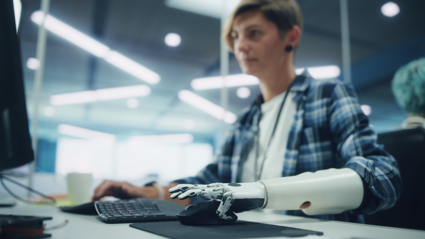 Diverse Body Positive Office: Portrait of Motivated Woman with Disability Using Prosthetic Arm to Work on Computer. Brave Professional with Futuristic Myoelectric Bionic Hand | Shutterstock HD Video #1078431404