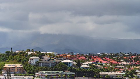 A sudden cloudburst sheds rain over the picturesque capital of Nouméa on the French island of New Caledonia - static time lapse