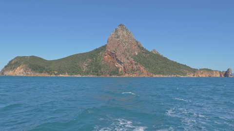 Distant View of Pentecost Island Amidst The Blue Water Of Coral Sea In Whitsundays, QLD, North Australlia. wide shot