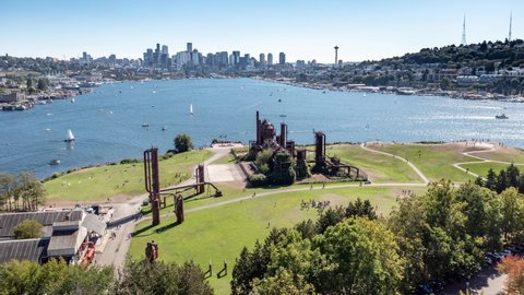 Cinematic drone trucking time lapse footage of sailboats by Gas Works Park, Lake Union, Queen Anne, Capitol Hill, Seattle, Space Needle in Western Washington, Pacific Northwest, King County