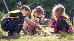 forest kindergarten. Happy Preschool group of children play in the swamp in park or forest. Outdoors small child have fun playing with mud in a woods. Hike. Scandinavian. curious, leisure in nature - Powered by Shutterstock - Get 15% off with code: PIKWIZARD15