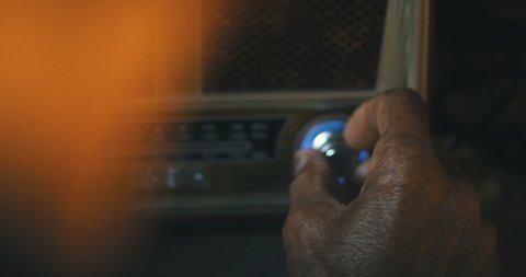 Old man hands choosing radio station
