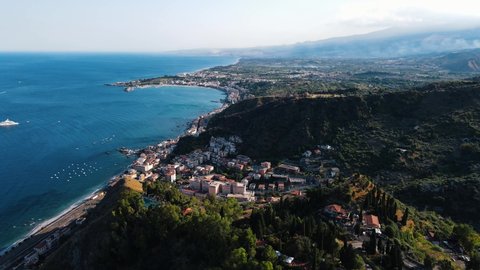Taormina, Sicily, Italy - drone shot of the cityscape while sunset.