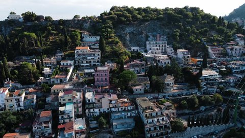 Taormina, Sicily, Italy - drone shot of the cityscape while sunset.