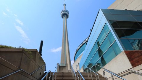 Toronto, Canada-5 May, 2021: Scenic CN Tower overlooking Ontario Lake. A panoramic view from the base of the tower to the top observation deck and Skypod lookout. (4K HQ)