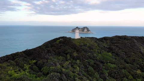 Aerial View Of East Cape Lighthouse On Otiki Hill With Whangaokeno (East Island) In The Distance In New Zealand. - approach