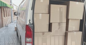 Animation of data processing over man packing boxes into car. global shipping, delivery and connections concept digitally generated video.