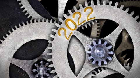 Tooth wheels in forward and backward rotation with New Year 2022 incoming and Old Year 2021 passing. High quality 4k video.
