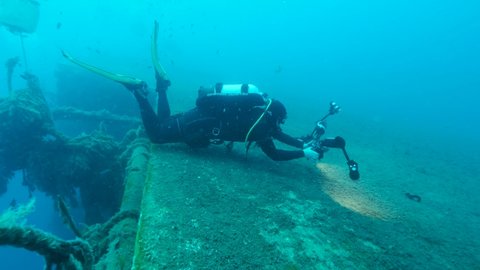 Scuba diver photographer shots on th shipwreck Swedish ferry MS Zenobia. Wreck diving. Mediterranean sea
