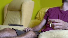 Fire hazard concept: man at home falls asleep while smoking cigarette.