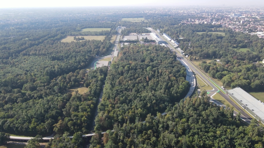 Aerial video of The Autodromo Nazionale of Monza, that is a race track located near the city of Monza, north of Milan, in Italy. Drone footage of the circuit in Monza. Grand prix in September.