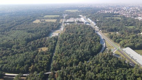 Aerial video of The Autodromo Nazionale of Monza, that is a race track located near the city of Monza, north of Milan, in Italy. Drone footage of the circuit in Monza. Grand prix in September.