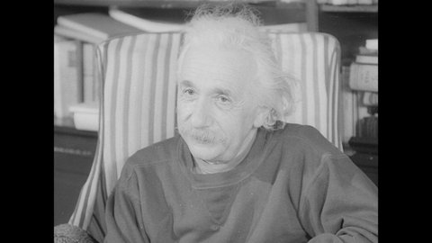 1940s: Albert Einstein sits in chair, leans forward, looks at letter, talks. Leo Szilard sits in chair.